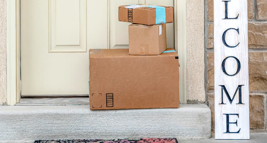 Packages on the doorstep of a home with a welcome sign in Harrisburg